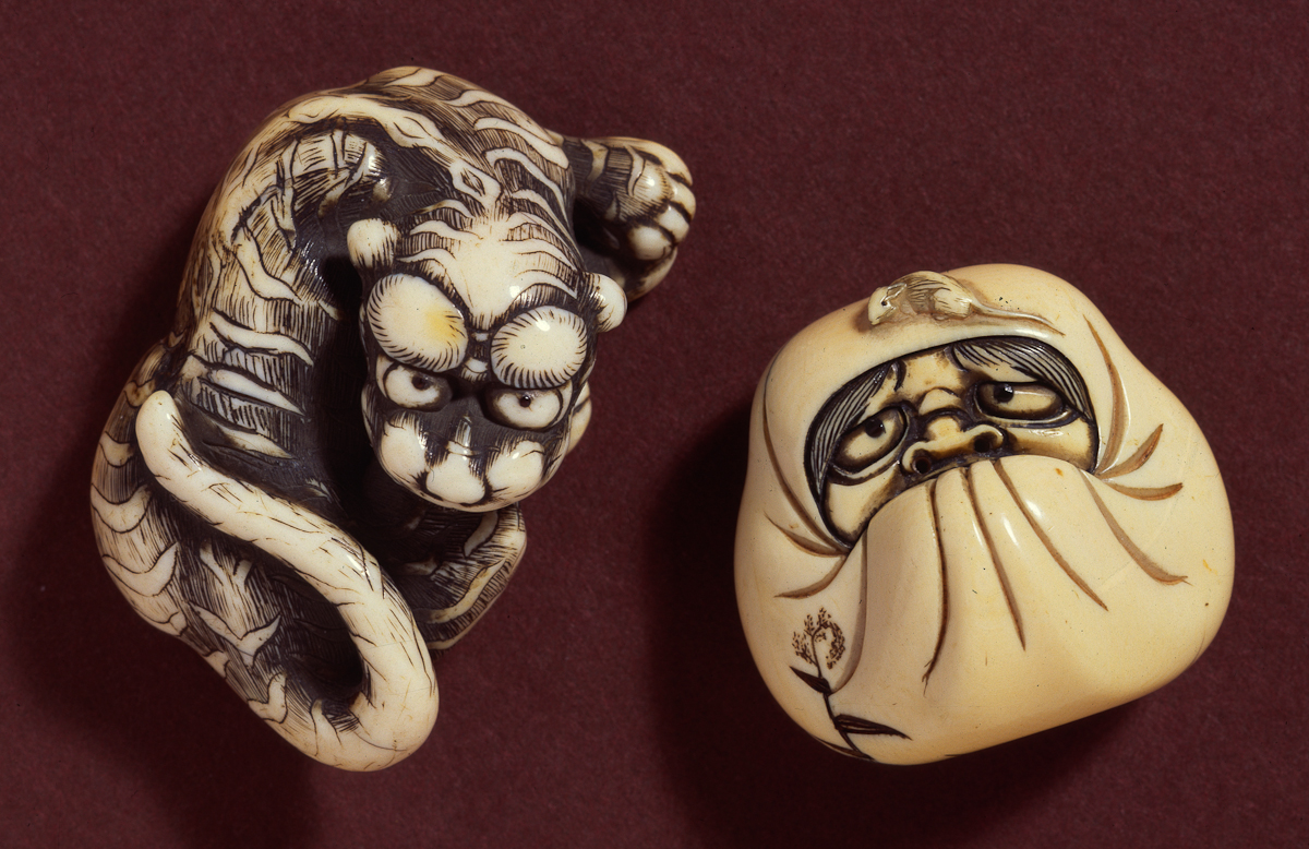 Daruma in meditation with rat crawling over his head